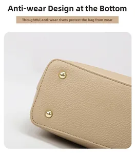 Detail of lychee leather tote bottom with protective golden metal anti-wear rivets