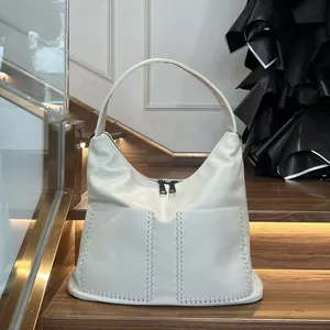 Detail of off-white leather hobo bag featuring hand-woven stitching and metal zippers