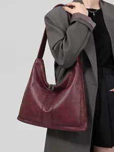 Classic burgundy leather tote bag with large capacity for women shown on a model