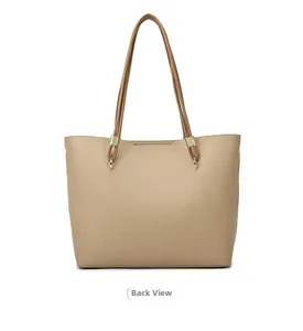 Detail view of khaki tote bag back side with lychee grain texture and gold hardware