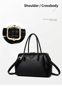 Detailed view of black lychee-grain leather handbag with premium gold-tone hardware