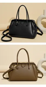 Detail of high-quality pebbled leather handbags in black and brown with gold hardware