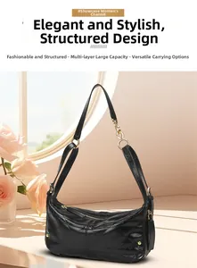 Detail of black quilted hobo shoulder bag with gold chain and elegant rhombus stitching
