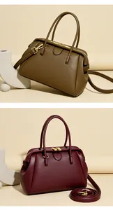 Detail of lychee pattern leather and gold hardware on classic doctor bag handbags