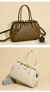 Detail view of tan and off-white pebbled leather handbags with gold hardware