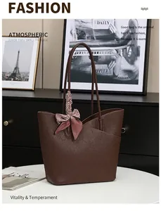 Detail of a brown leather tote bag with houndstooth silk scarf on a stylish table