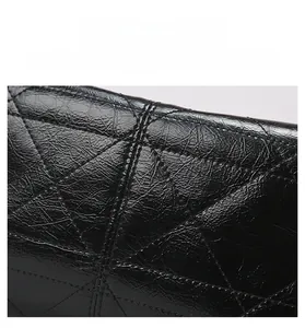Macro detail of high-quality black quilted leather texture with durable diamond stitching