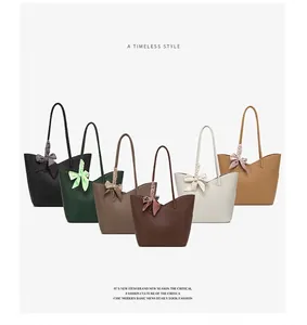 Detail of large tote bags in six colors with decorative bow scarves and lychee texture