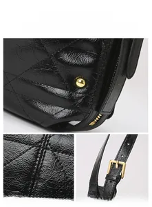 Detailed macro view of quilted glossy leather texture and gold hardware on shoulder bag