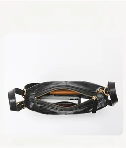 Top view of spacious quilted black leather bag interior with multiple compartments