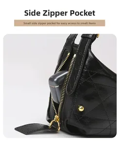 Detail view of the black quilted shoulder bag featuring a functional side gold zipper pocket