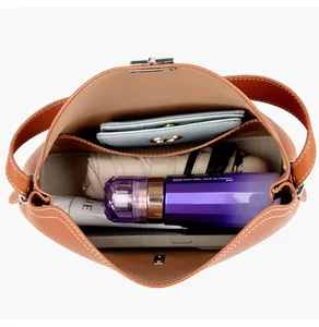 Top view of spacious interior of brown leather tote bag with various organized items
