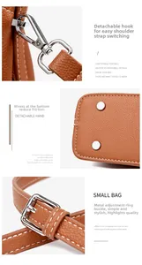 Detail view of brown leather handbag featuring silver metal hooks and protective bottom studs