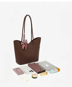 Brown leather tote bag interior view showing space for a tablet, phone, and wallet