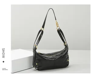 Close-up of black quilted leather hobo bag with gold zipper and refined metal hardware