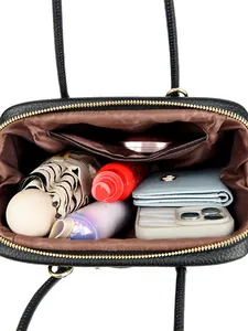 Black pebbled leather tote bag with large capacity showing organized daily essentials