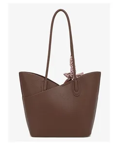 Close-up of deep brown lychee grain leather tote bag featuring decorative patterned silk scarf