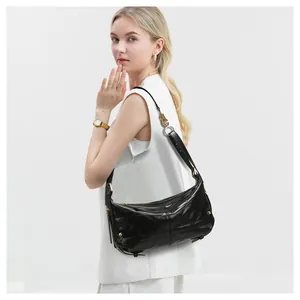 Close-up of quilted black leather hobo bag with luxury gold zipper and hardware