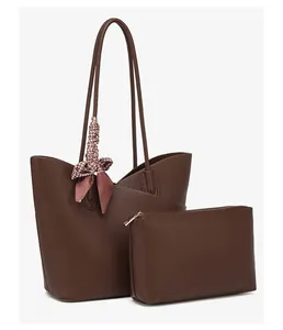 Detail of dark brown pebble leather tote bag with a small matching zippered clutch pouch