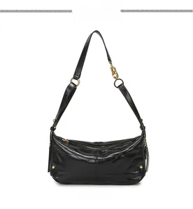 Close-up of black quilted leather shoulder bag with gold hardware and chain detail