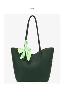 Detail of dark green tote bag with lychee grain leather and decorative houndstooth scarf