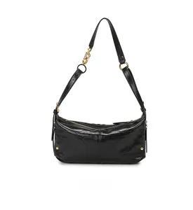 Detailed view of the black quilted shoulder bag with glossy finish and gold metal hardware