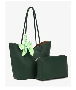 Detail of dark green pebble leather tote bag with matching pouch and patterned scarf