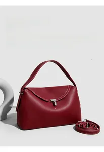 Detail of burgundy lychee leather bag with white contrast stitching and silver T-lock