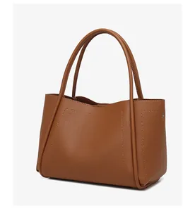 Detail van de karamelkleurige shopper van hoogwaardig leer met een litchi-nerf