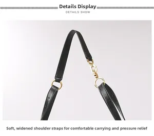 Detail view of the soft wide black leather shoulder strap with gold metal buckle