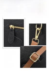 Detail of adjustable detachable leather strap and golden hardware on black tote bag