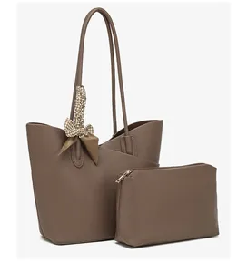Detail of taupe tote bag and matching pouch with textured leather and houndstooth scarf