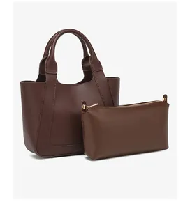 Detailweergave van de donkerbruine leren tote bag met bijpassend ritszakje