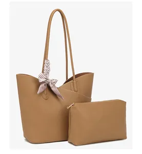 Detail of brown textured tote bag set with inner pouch and houndstooth silk scarf