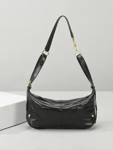Chic black quilted dumpling shoulder bag with gold hardware and glossy leather finish