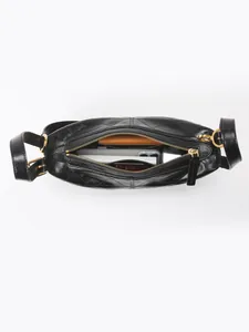 Black quilted oil wax leather shoulder bag with gold zipper showing spacious interior