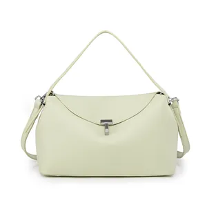 Close-up of light green lychee grain leather handbag with silver T-shaped metal buckle