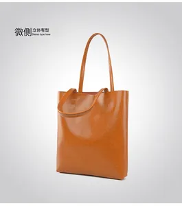 Detail view of the caramel leather tote bag showing its side profile and textured finish