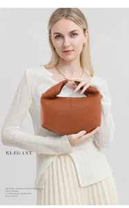 Brown lychee leather tote bag with unique pointed bottom and elegant gold metal handle