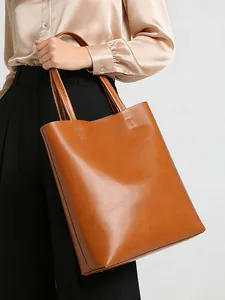 Caramel leather tote bag on model showing large capacity and stylish minimalist texture