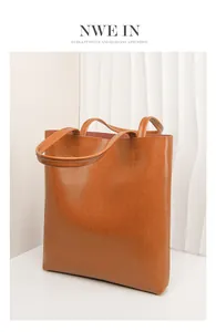 Close-up of brown oil wax leather tote bag with natural texture and reinforced stitching