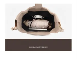 Internal view of the beige leather bucket bag showing main compartment storage capacity