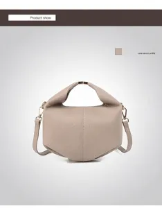 Detail of off-white lychee grain leather crossbody bag with metal ring handle and folding design