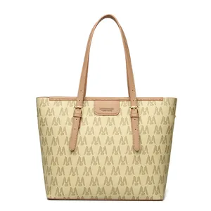 Chic cream tote bag with brown 'M' logo pattern and premium leather straps