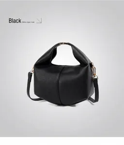 Detail view of black lychee grain leather crossbody bag with golden metal hardware