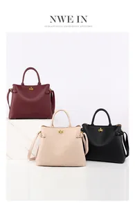 Detailed shot of litchi textured leather handbags in burgundy, beige and black colors