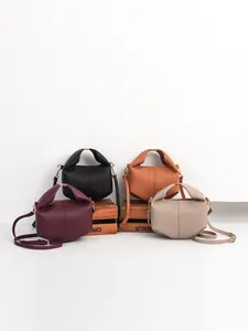 Minimalist leather crossbody bags in four colors with geometric folding design and top handles