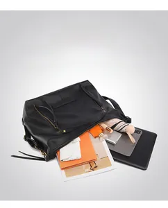 Detailed view of spacious black tote bag interior showing storage capacity for daily essentials