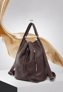Detail of dark brown lychee grain leather texture and drawstring on large commute backpack