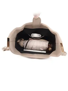 Spacious light khaki lychee pattern leather handbag showing interior storage capacity